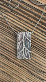 Load and play video in Gallery viewer, Cedar Sprig Shield Pendant — Sterling Silver Nature Window Necklace #S745
