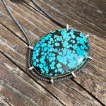 Load image into Gallery viewer, authentic turquoise horizontal oval shaped pendant on unique setting weathered driftwood background
