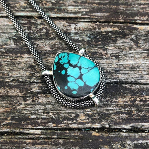 authentic turquoise tear shaped pendant on unique setting  with beautiful oxidized Sterling Silver chain weathered driftwood background